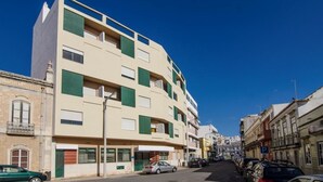 A multi-story building with a flat facade, balconies, and a ground-level entrance. - Faro Albacor Residence - Hostel (Faro)