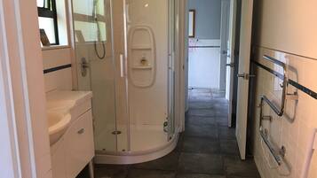 Shower, hair dryer, soap, toilet paper