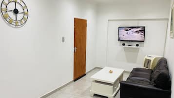 Family Suite | Living area | 32-inch LCD TV with satellite channels, TV