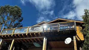 A wooden cabin with a glass balcony, a satellite dish, and a clear blue sky. - 4 **** CHALET WITH TOURISM CLASSIFICATION  (Les Angles)