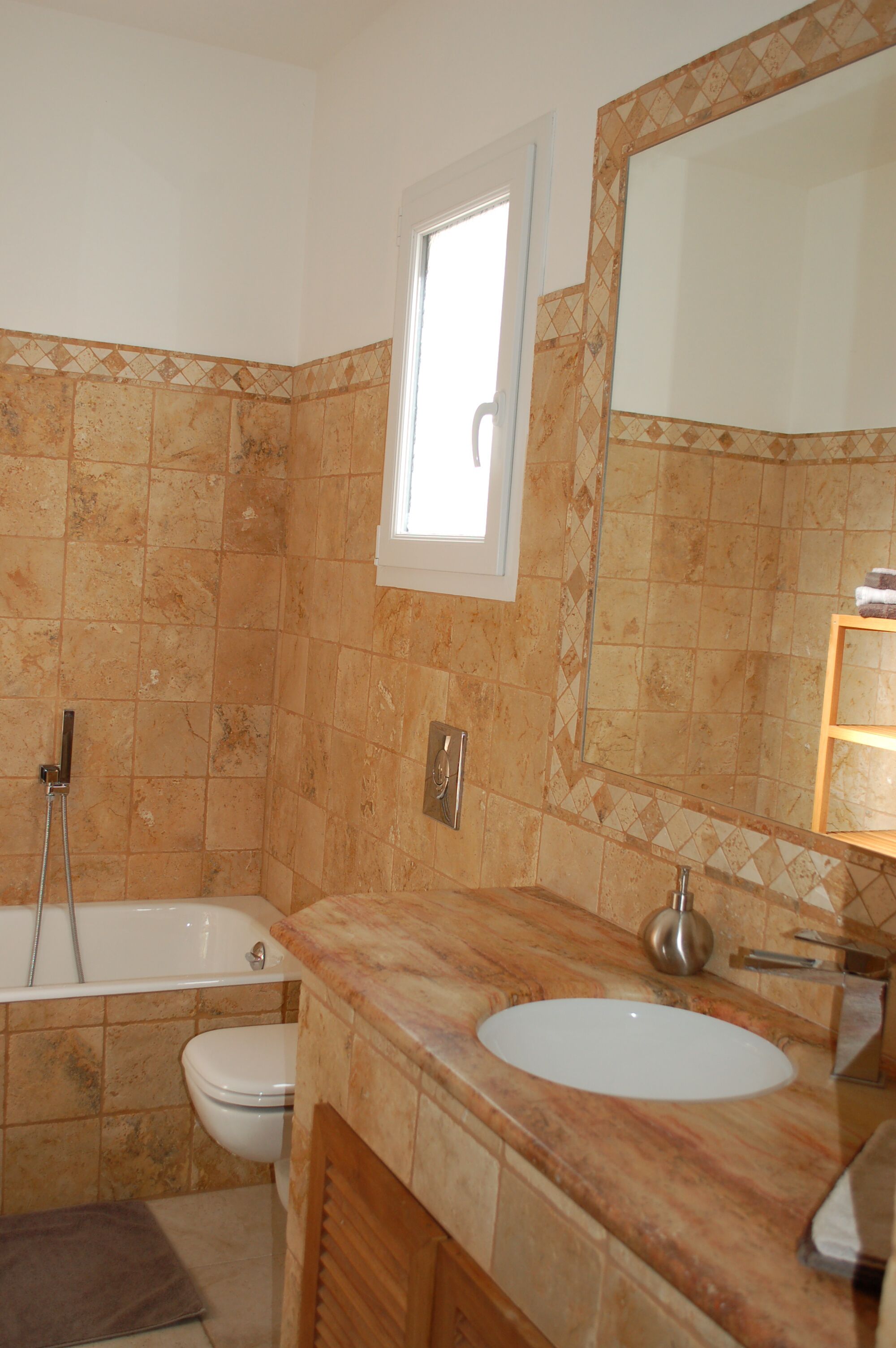 A bathroom with a bathtub, toilet, and sink.