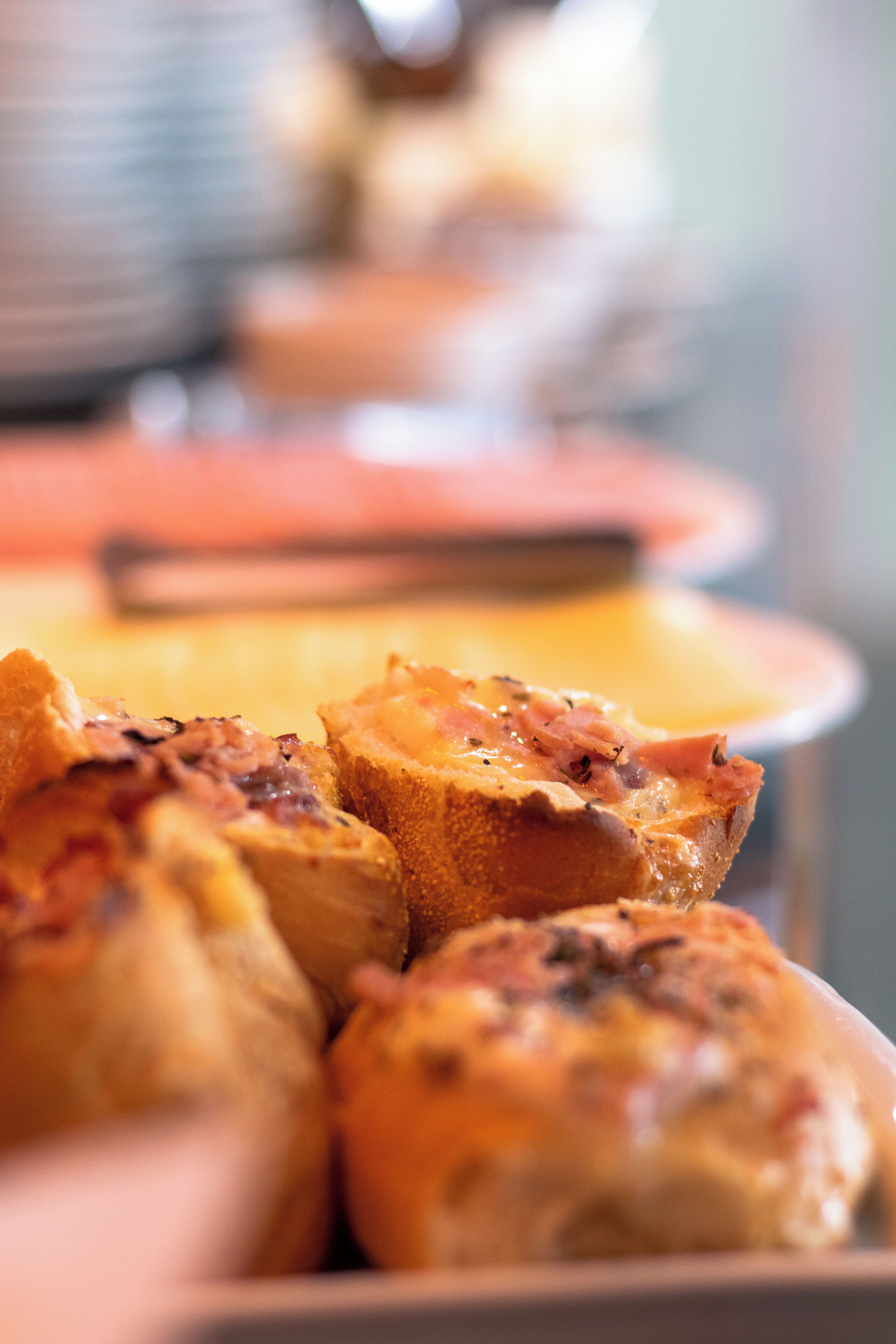 A close-up of food items, likely pastries, with a blurred background suggesting a dining setting.