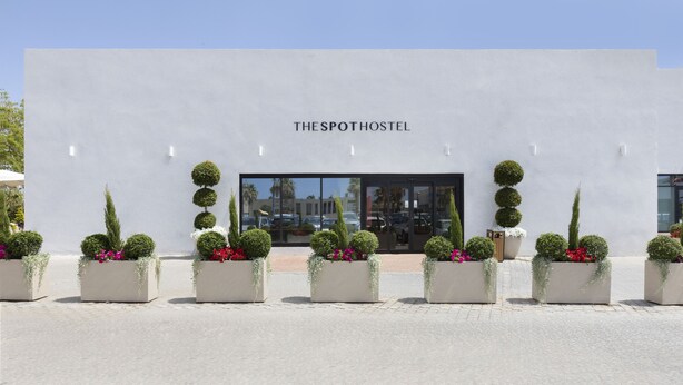 A modern building with the sign "THE SPOTHOSTEL" above the entrance. - The Spot Hostel (Tel Aviv)