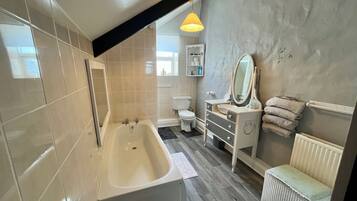 Bathtub, hair dryer, towels, soap