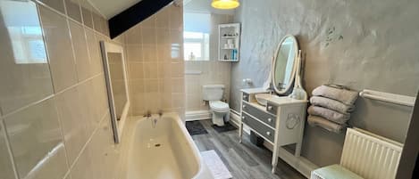Bathtub, hair dryer, towels, soap