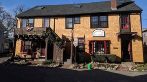 A two-story building with a sign for 'Brampton Leather Co.' on the front.