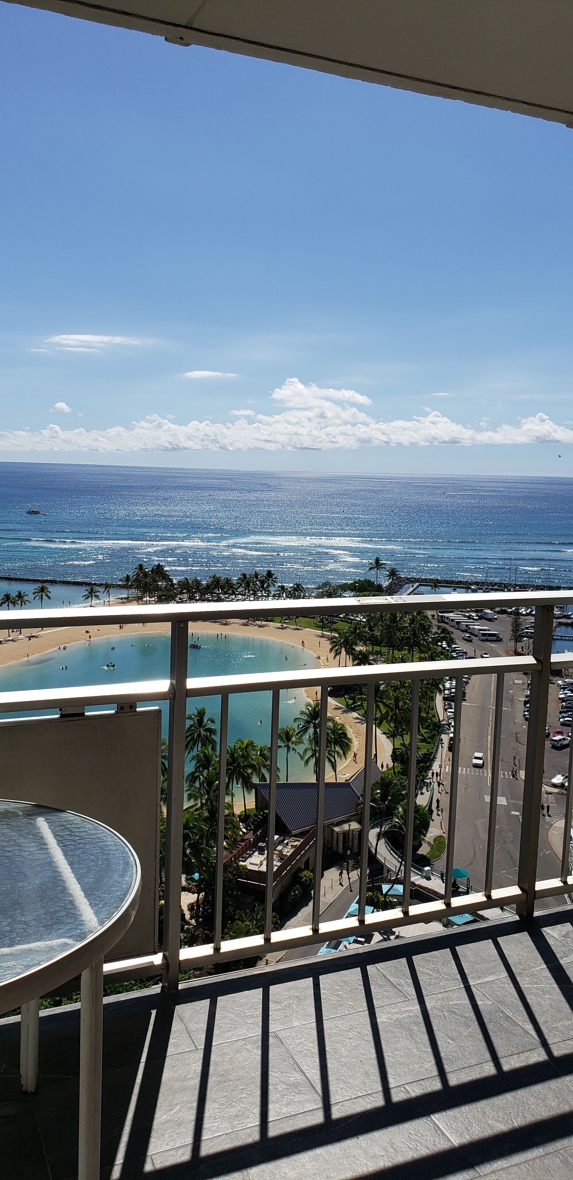 A balcony with a view of a beach and ocean.