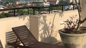 A balcony with a view of a cityscape, including a distinctive tower. - Hedges Court Residencies Town Hall-2 Room 3 Bed Apartment (Colombo)