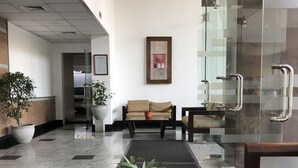 A lobby with a glass coffee table, seating area, and potted plants. - Hedges Court Residencies Town Hall-2 Room 3 Bed Apartment (Colombo)