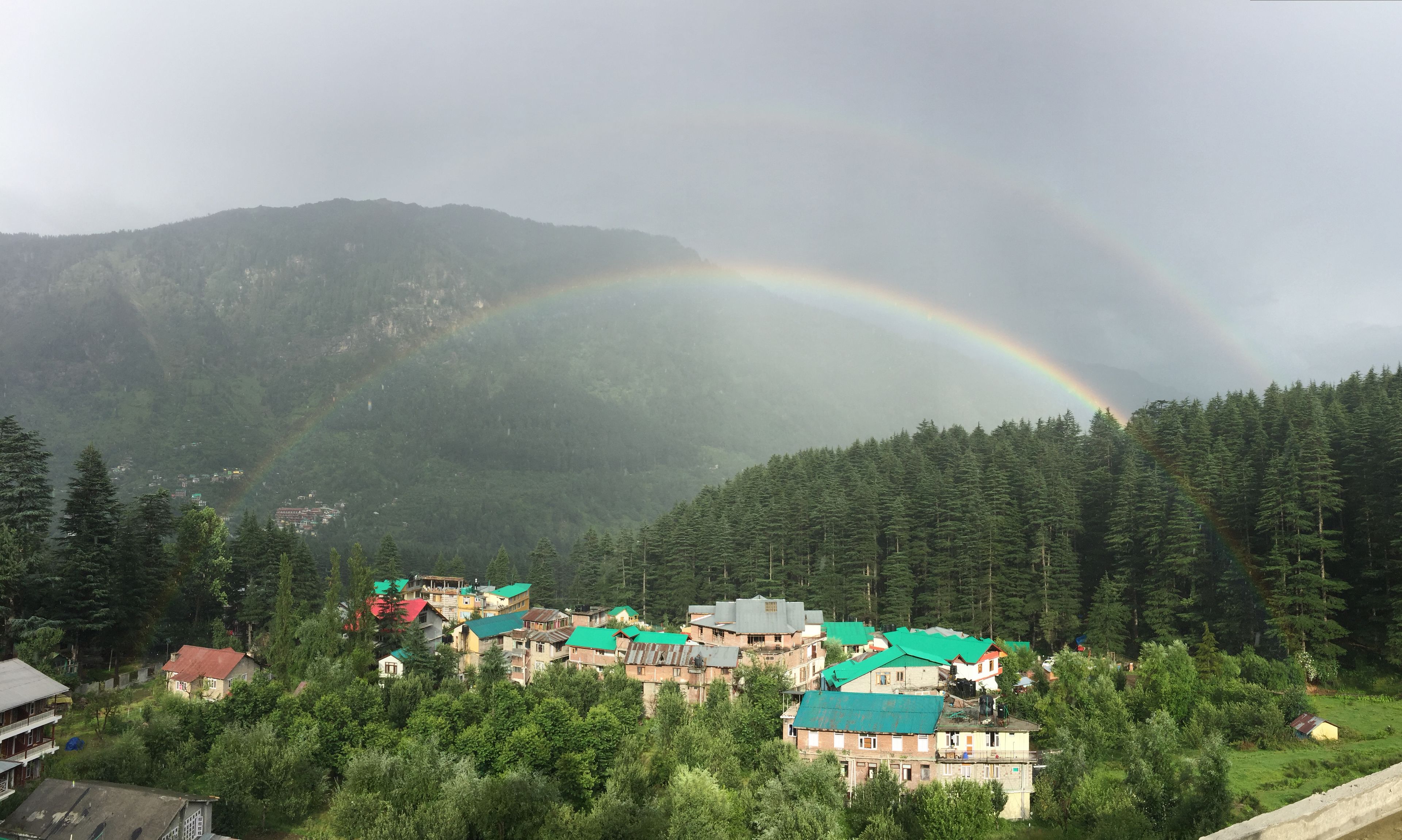 A village with houses and a mountain backdrop.