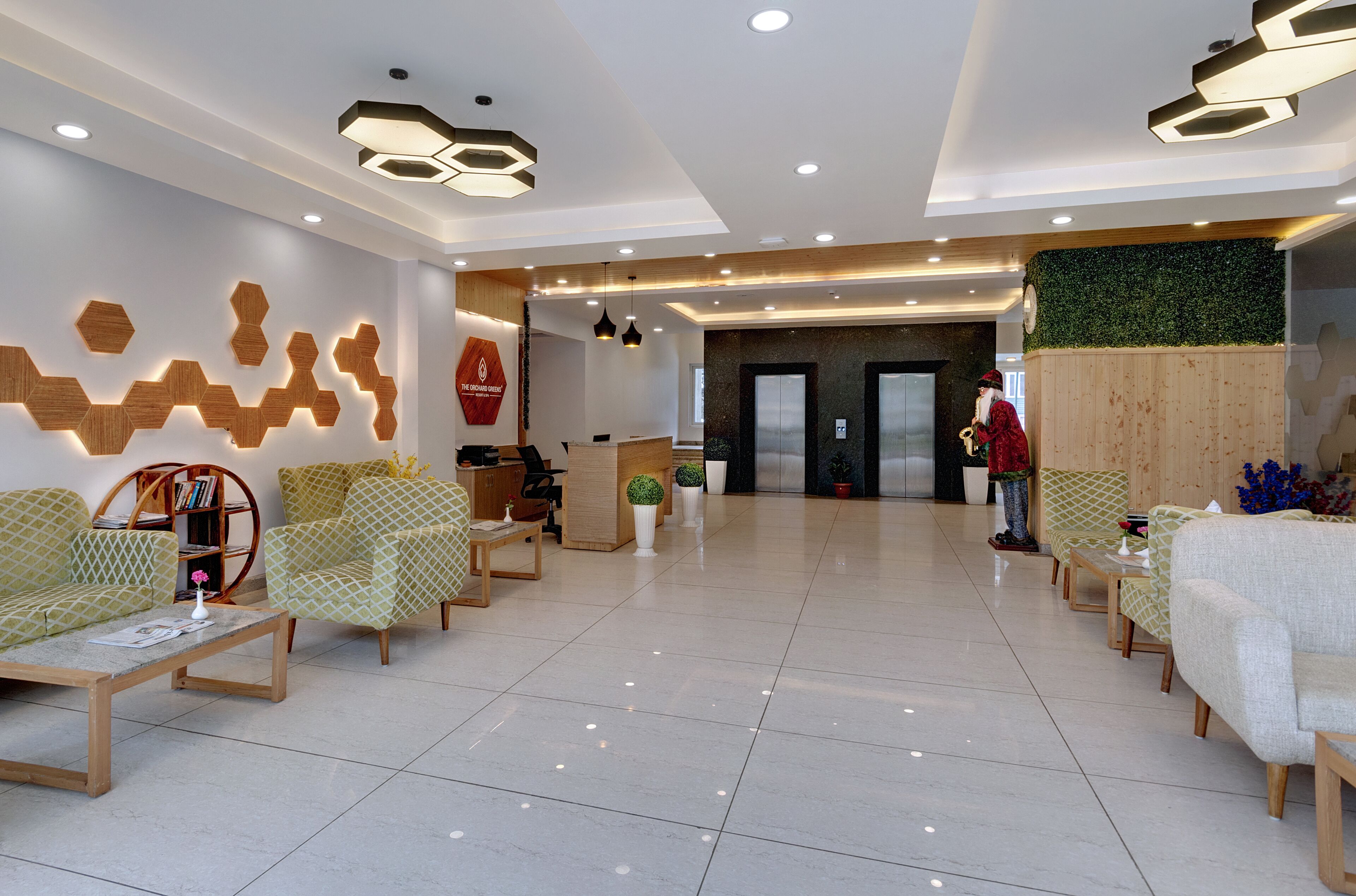 A modern reception area with hexagonal wooden wall decor, a reception desk, and seating arrangements.