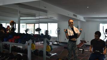 Een sportschool met gewichthefapparatuur, loopbanden en fitnessapparaten.