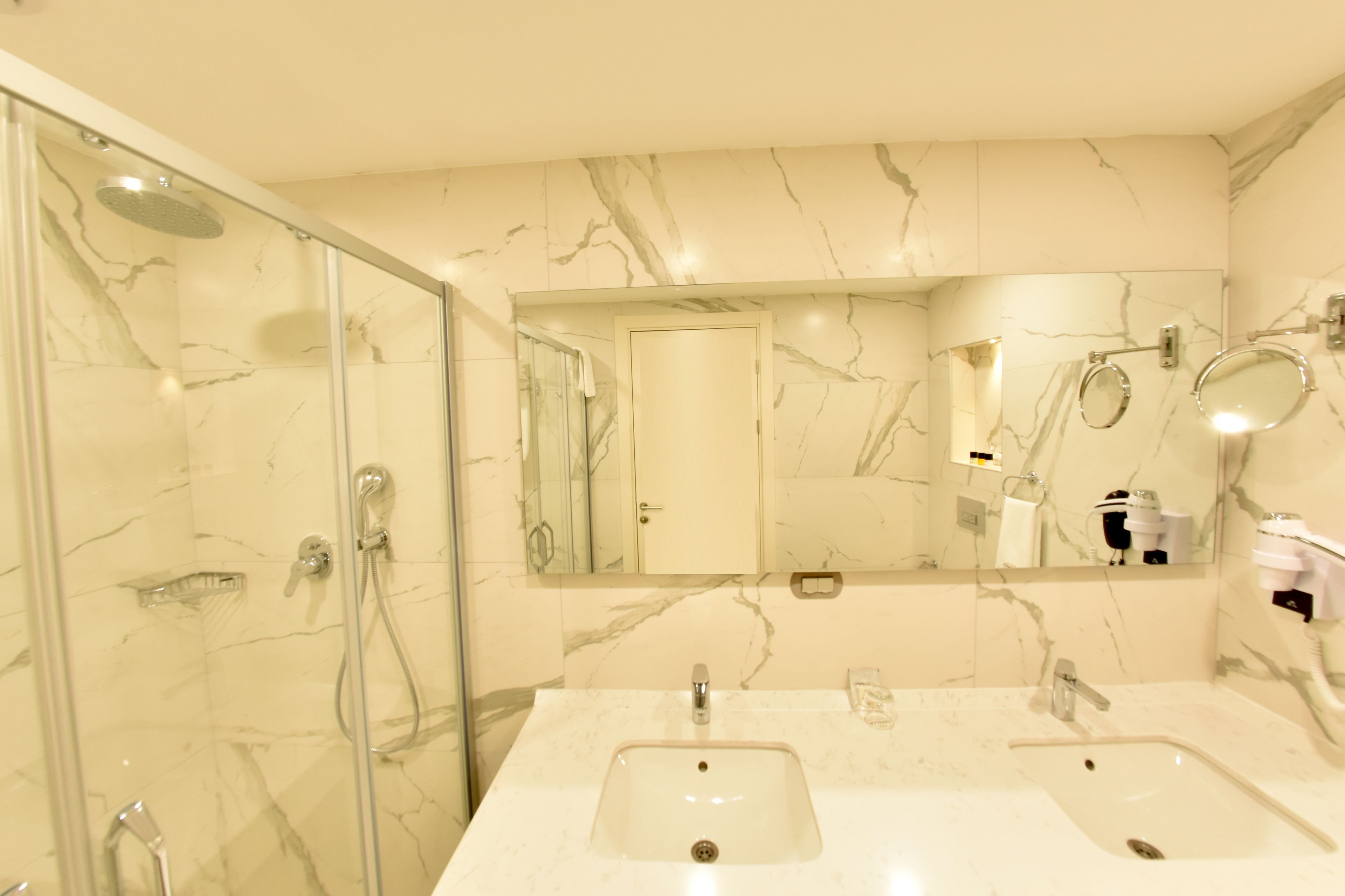 family suite, 1 king bed, non smoking, city view | bathroom | designer toiletries, hair dryer, slippers, towels