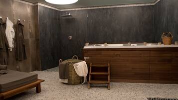 Enjoy a refreshing shower in this bathroom featuring a large mirror, sink, and shower area.