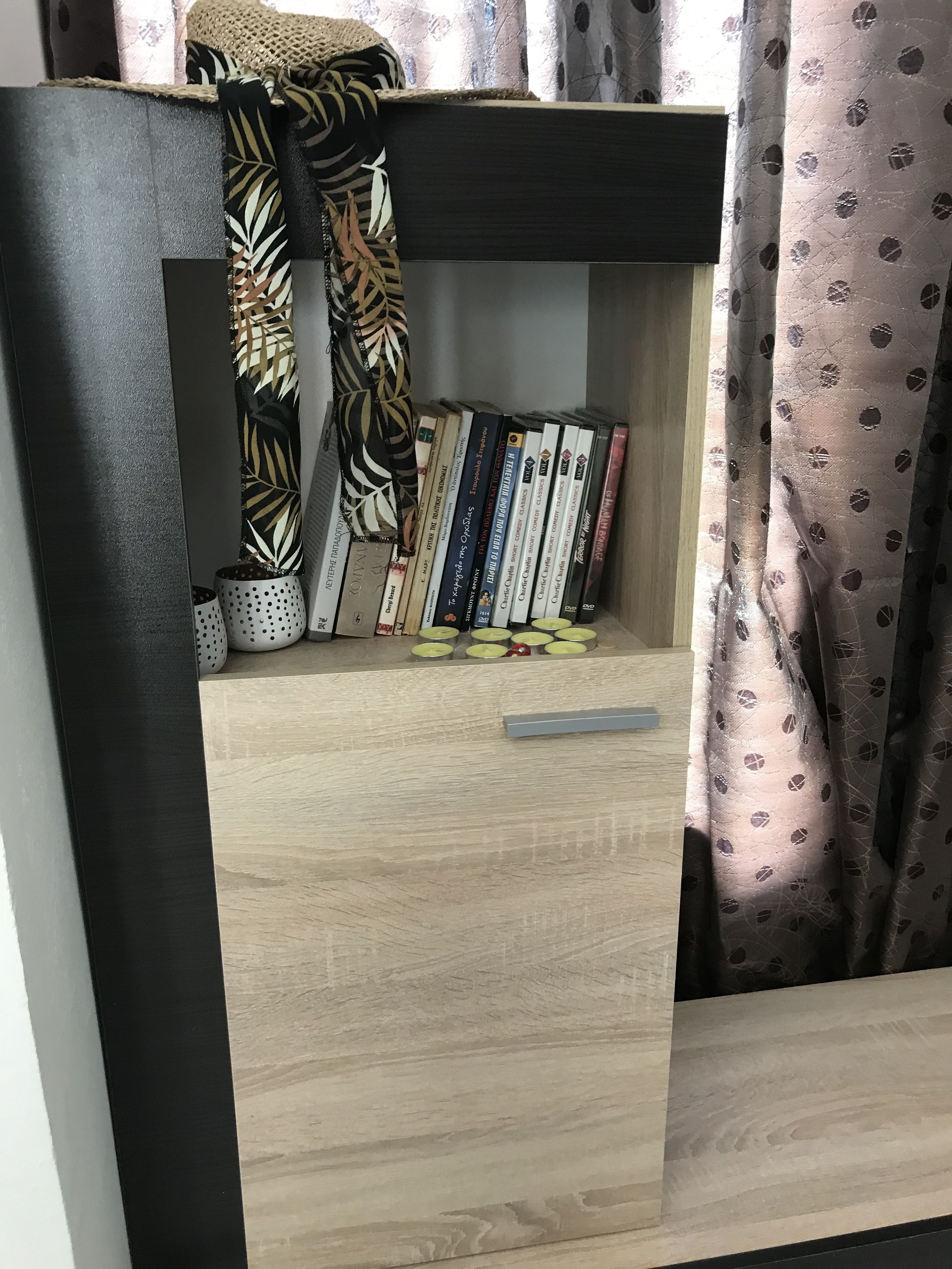 A bookshelf with books and decorative items.