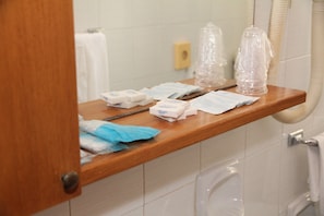 A bathroom shelf with toiletries and a tissue box. - Hotel Da Remo (Roccaraso)