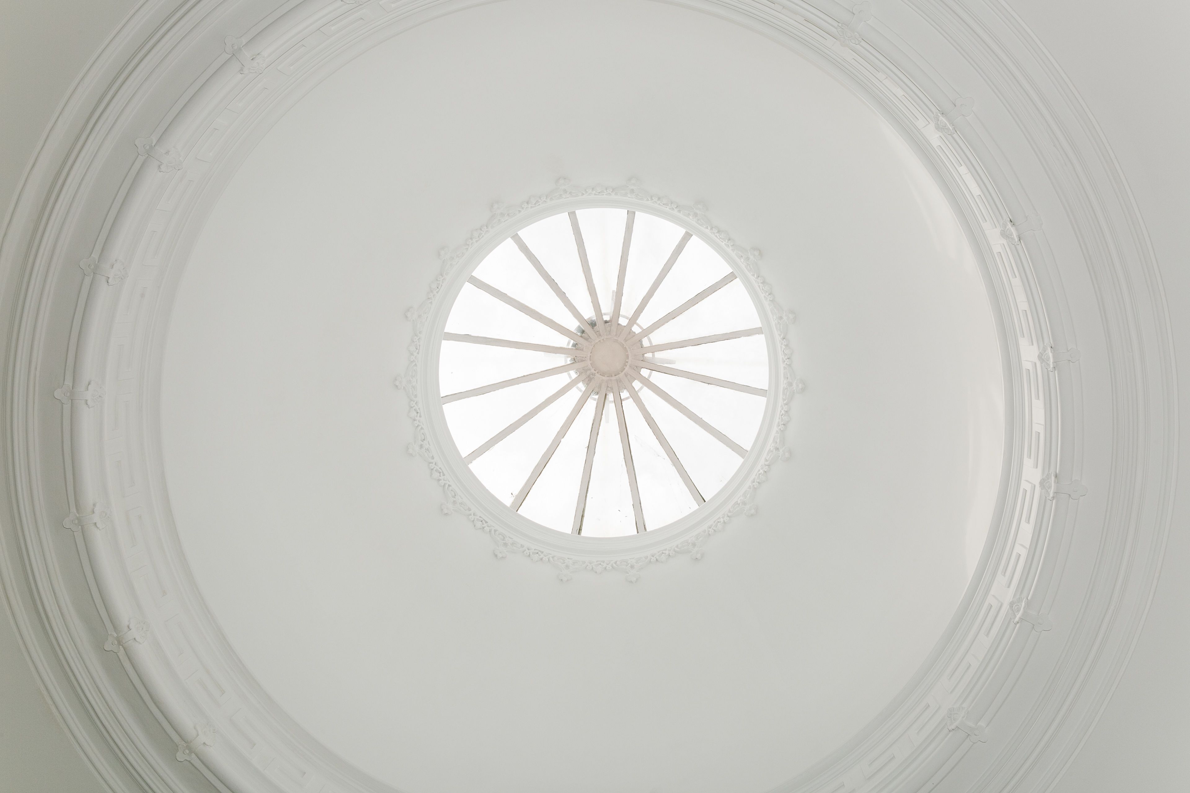 Un tragaluz circular con un diseño central y elementos que irradian desde él.