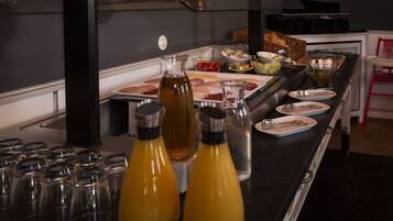 A buffet setup with various food items and condiments.