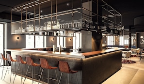 Zona de bar moderna con barra, taburetes y una variedad de botellas y copas.
