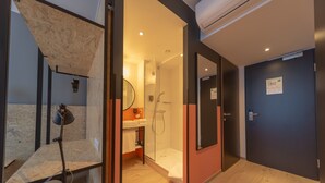 A modern bathroom with a glass shower enclosure, a wooden vanity, and a mirror. - ibis Styles Wien Messe Prater (Vienna)