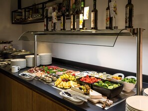 A buffet with various food items, including meats, cheeses, fruits, and vegetables. - ibis Styles Wien Messe Prater (Vienna)