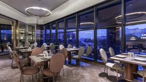 A modern dining area with large windows, marble flooring, and contemporary furniture. - Mercure Suzhou Jinji Lake (Suzhou)