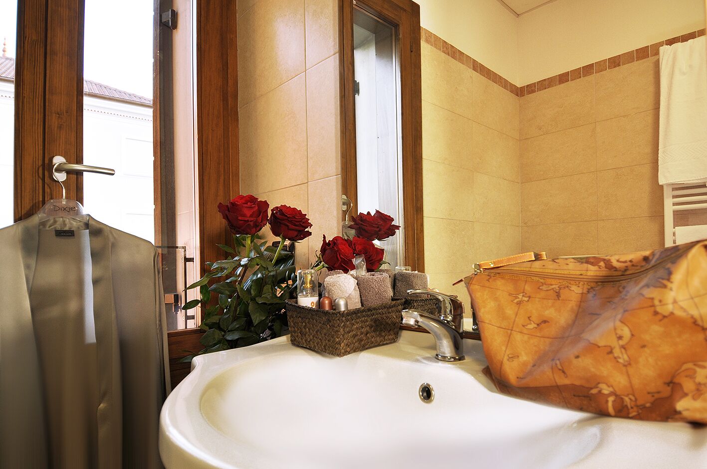 A bathroom with a sink, a wooden door, and a window.