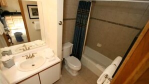 A bathroom with a shower, toilet, and sink. - Spacious Condo with Outdoor Heated Pool and Hot Tubs by RedAwning (Vail)
