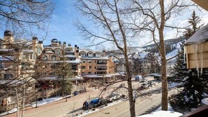 A snowy town with historic buildings and a clear road.