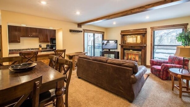 A spacious living area with a fireplace, a television, and a cozy seating arrangement.