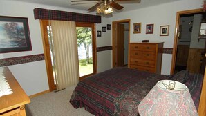 A bedroom with a bed, dresser, and a ceiling fan. - Ranch-Style Seidls Home Feet away to Lakeshore by RedAwning (Cable)