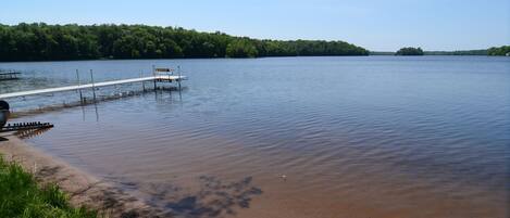 A calm lake with a wooden dock extending into the water.