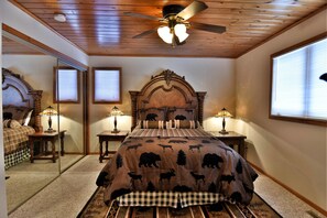 A bedroom with a large bed, wooden ceiling, and a ceiling fan. There are two bedside tables with lamps and a window with blinds. - Peace Of Mind On Namakagon 5 Bedroom Hotel Room by RedAwning (Cable)