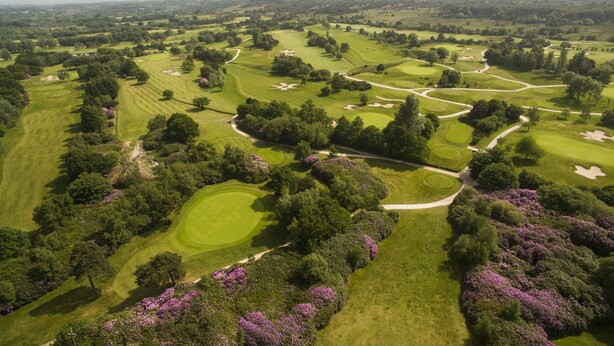 An aerial view of a golf course with multiple fairways, sand traps, and lush greenery. - The Dorset Golf Hotel (Wareham)