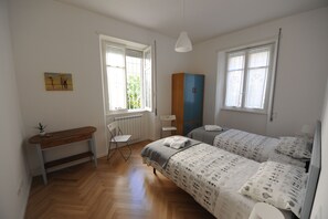 2 habitaciones, escritorio y tabla de planchar con plancha