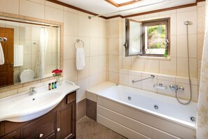 Bathtub, eco-friendly toiletries, hair dryer, towels