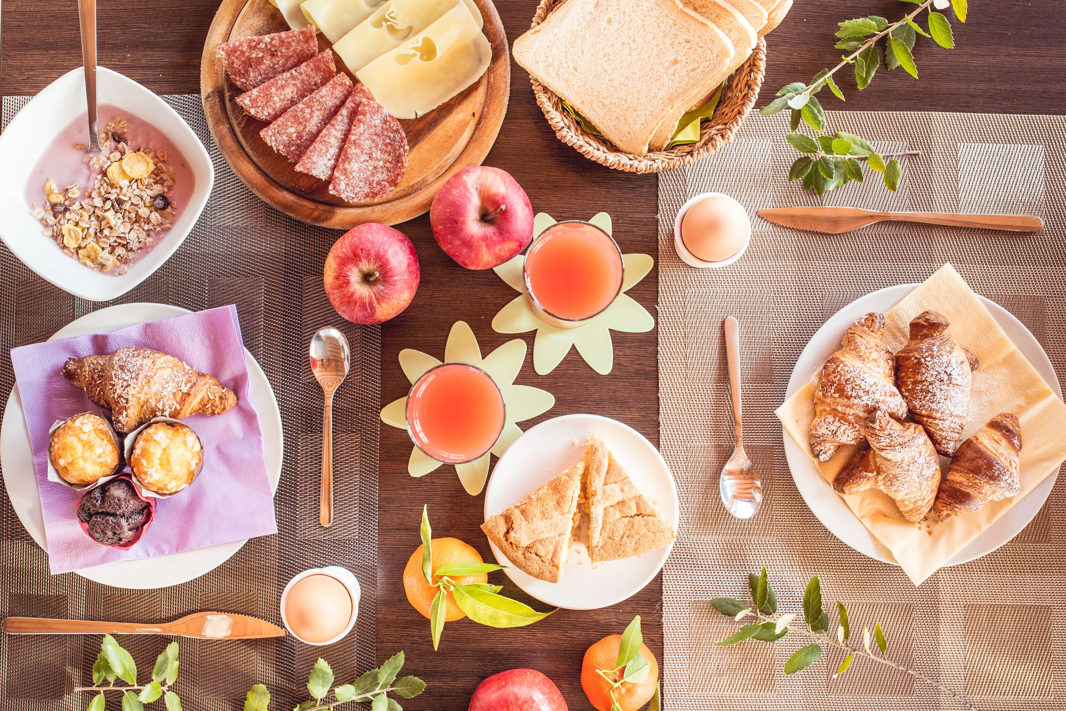 A breakfast setting with various foods and drinks.