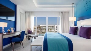 A hotel room with a bed, desk, chair, and a view of the city. - Vichy Célestins Spa Hôtel Casablanca (Casablanca)