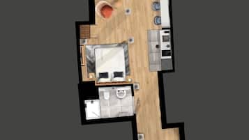 Vista cenital de una habitación de hotel con cama, baño pequeño, kitchenette y zona de estar con mesa y sillas.
