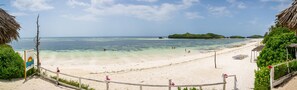 A beach with clear turquoise water, a sandy shore, and a sign indicating 'Trullo Beach'. - Ocean Breeze Villa (Watamu)