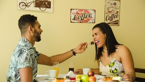 A dining table with plates of food, a glass of orange juice, and a coffee cup. - Hotel do Sol Executive (São Sebastião)