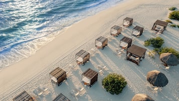 On the beach, white sand, free beach cabanas, sun loungers