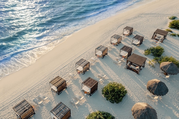 On the beach, white sand, free beach cabanas, sun loungers