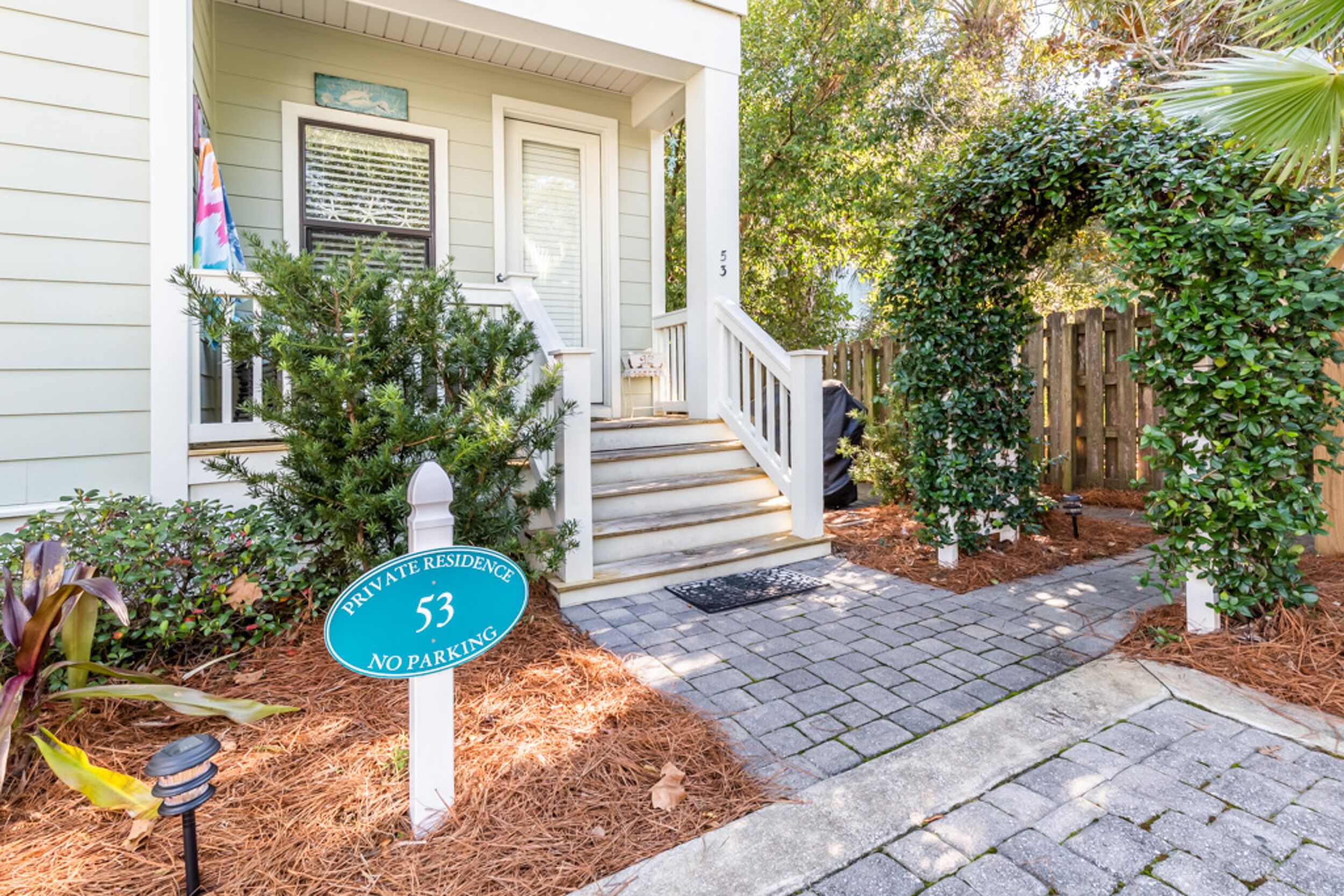 A private residence with a no parking sign, a front porch, and a pathway leading to the entrance.