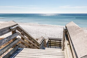 A wooden staircase leading to a sandy beach with a clear view of the ocean. - Coastal Beach Home Steps from the Beach, Trails, Dining & Shopping (Santa Rosa Beach)