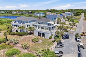 A coastal residential area with houses, a dock, and a parking lot.