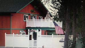 A red building with a white fence and an American flag. - "Serene, tranquil home near Glacier National Park, great for 2 Families!" (Columbia Falls)