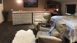 A bedroom with a bed, a desk, a chair, a dresser, and a painting on the wall. - "Serene, tranquil home near Glacier National Park, great for 2 Families!" (Columbia Falls)