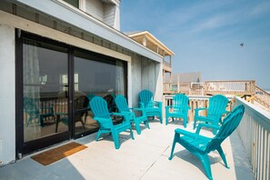 Relax in style with Adirondack chairs surrounding a small table on a patio.