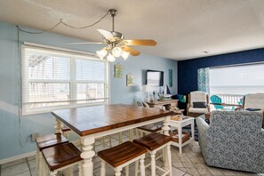 Enjoy meals in this dining area with a wooden table and comfortable seating for guests.